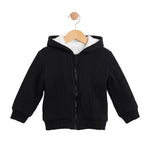 Black zip-up hoodie on a wooden hanger against a white background