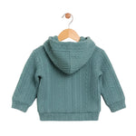 Green knitted hoodie on a wooden hanger against a white background