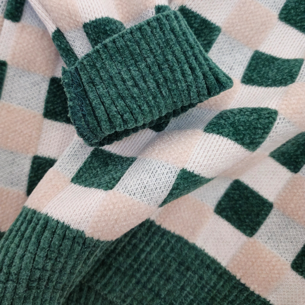 Green textured socks on a checkered fabric background