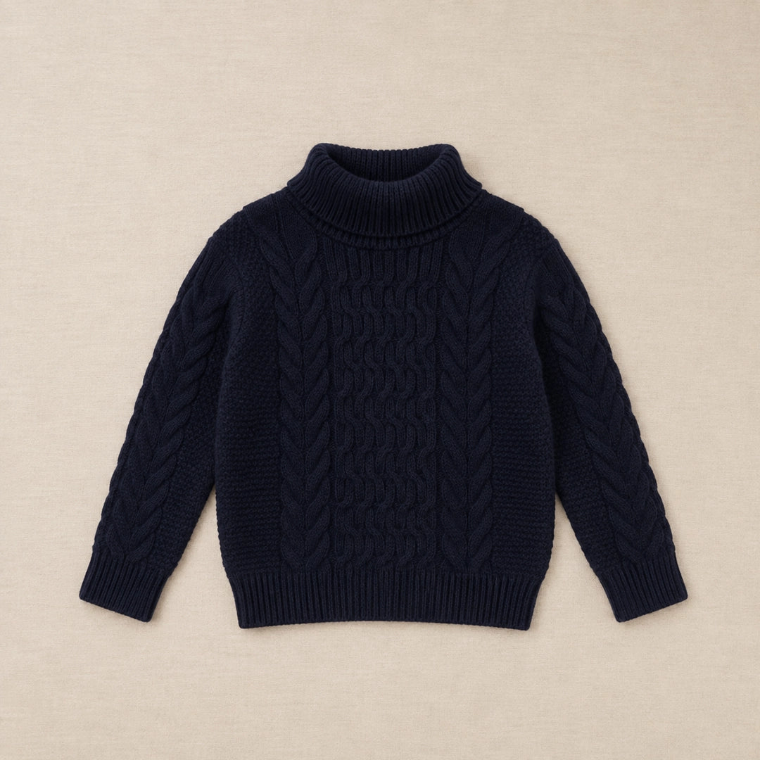 Navy blue cable knit sweater on a hanger against a white background