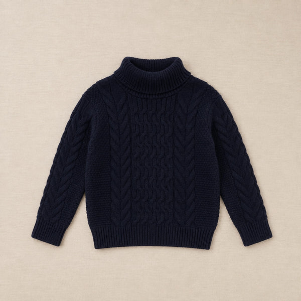 Navy blue cable knit sweater on a hanger against a white background