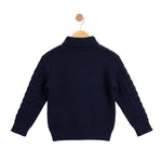 Navy blue sweater on a wooden hanger against a light gray background
