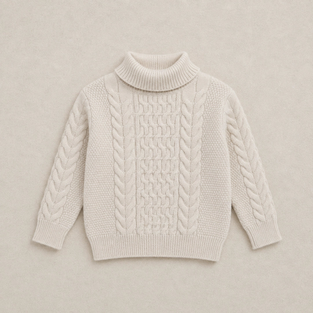 Beige cable knit sweater on a wooden hanger against a white background
