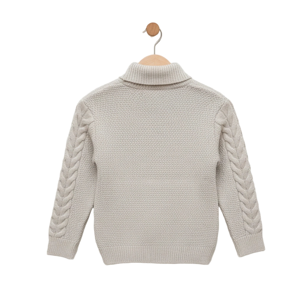 Beige knitted sweater with braided sleeves on a wooden hanger against a light gray background