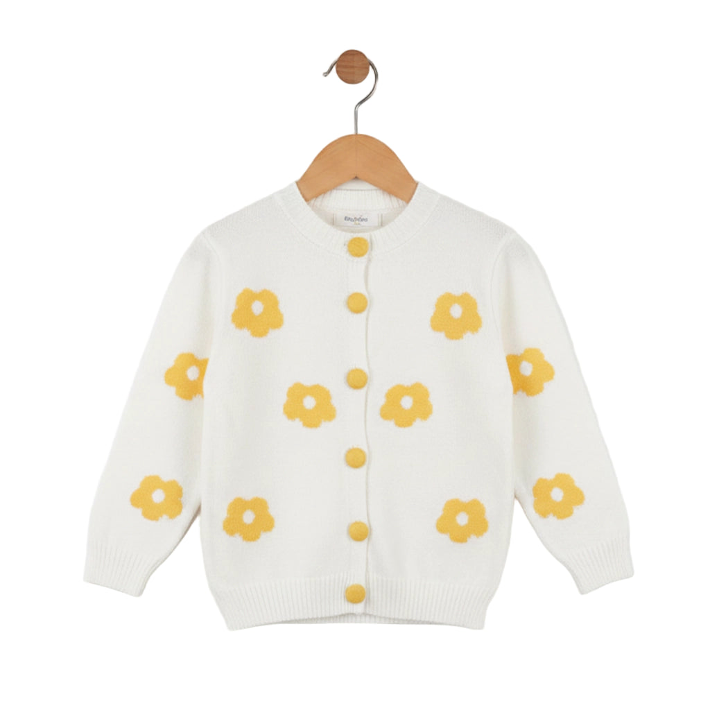 White cardigan with yellow floral patterns on a wooden hanger against a white background