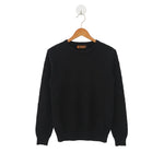 Navy blue sweater on a wooden hanger against a white background