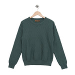 Green sweater on a wooden hanger against a white background