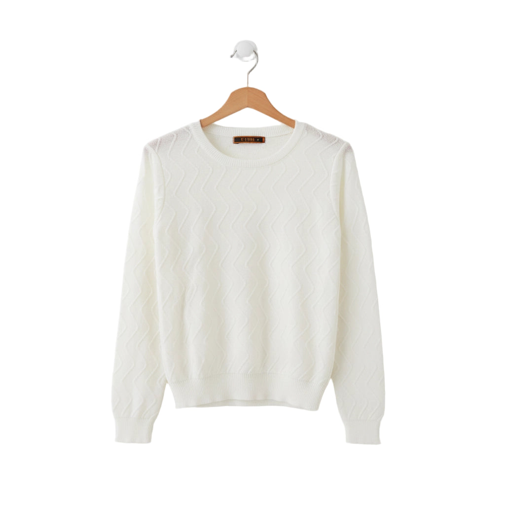 White sweater on a wooden hanger against a white background