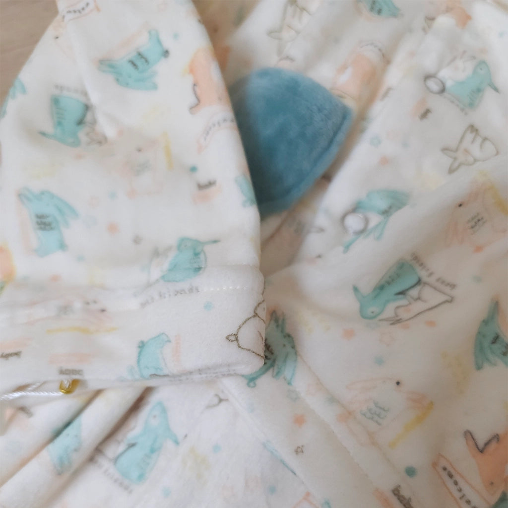 Baby blanket with cartoon designs on a neutral background