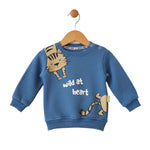 Blue children's sweatshirt with a cat design and 'wild at heart' text on a hanger against a white background