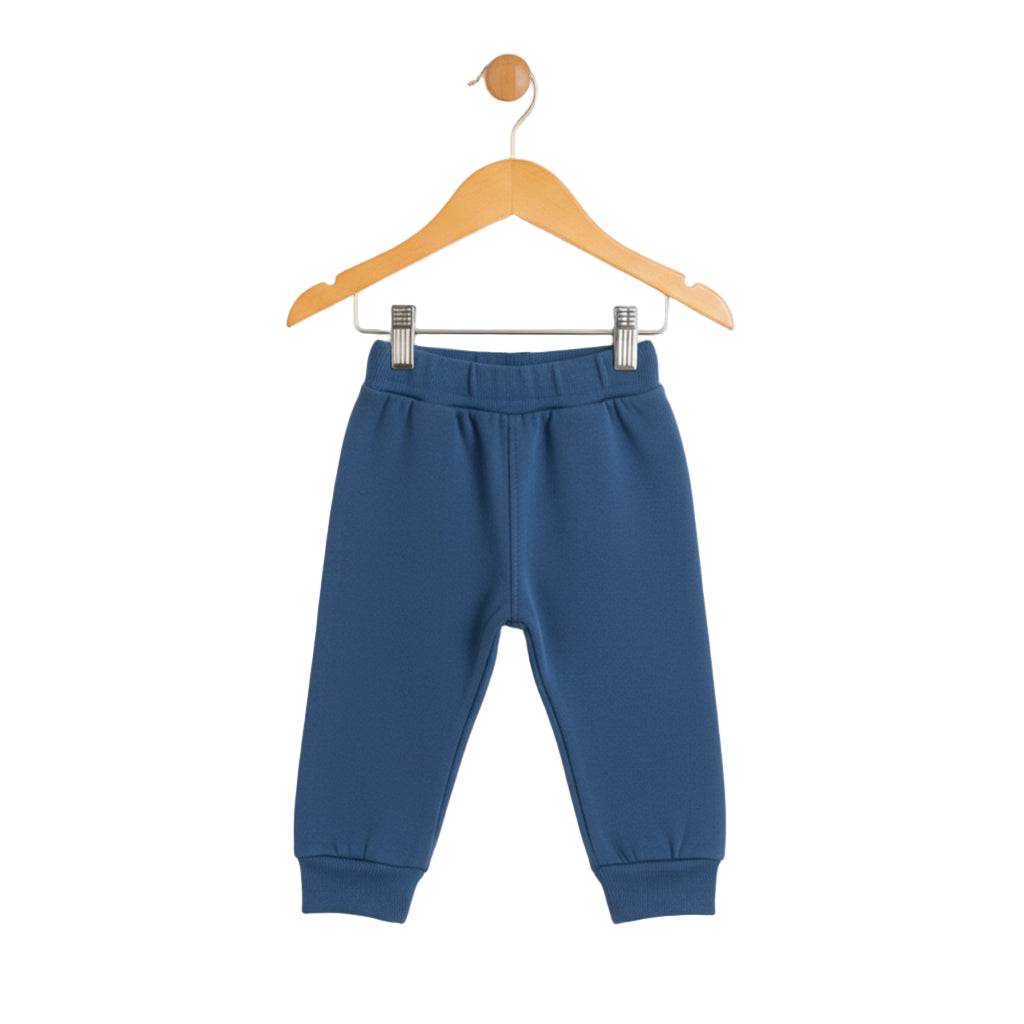 Blue children's pants on a wooden hanger against a white background