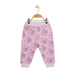 Pink children's pants with a pattern on a hanger against a white background