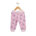 Pink baby pants with cartoon character pattern on a hanger against a white background