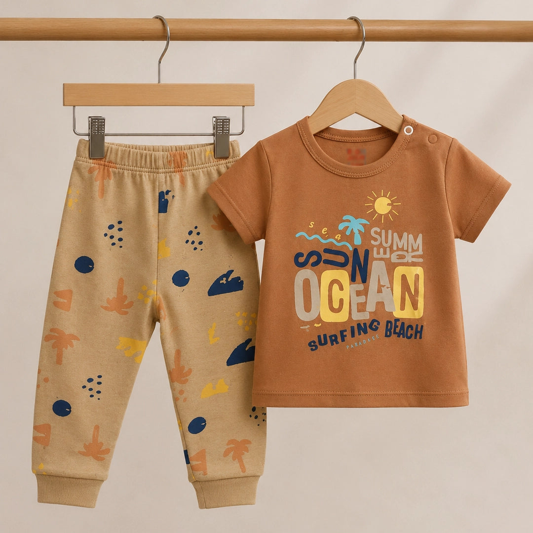 Children's brown shirt and pants set with beach-themed design on a beige background
