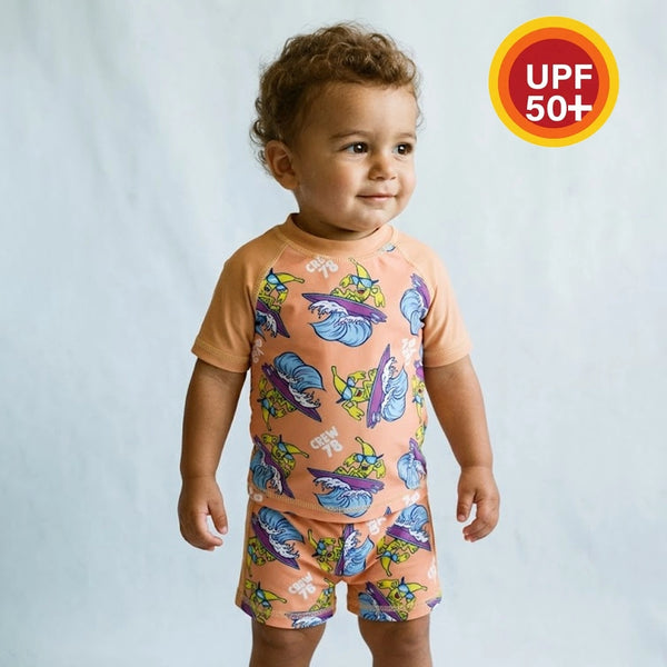 Child wearing a colorful outfit with a UPF 50+ label on a plain background