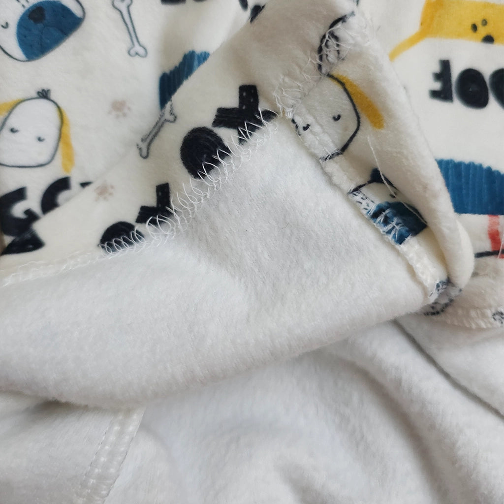 Close-up of a folded fabric with cartoon characters and text.