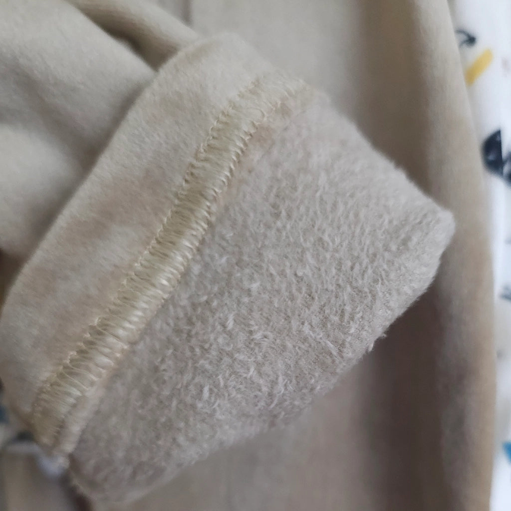 Close-up of beige fabric with visible stitching