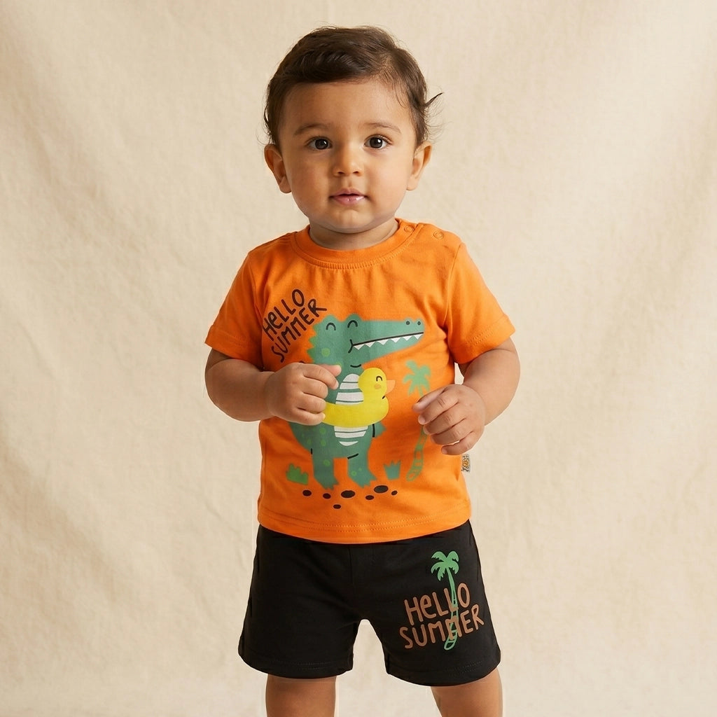 Child wearing an orange shirt with a dinosaur graphic and black shorts with 'Hello Summer' text on a beige background