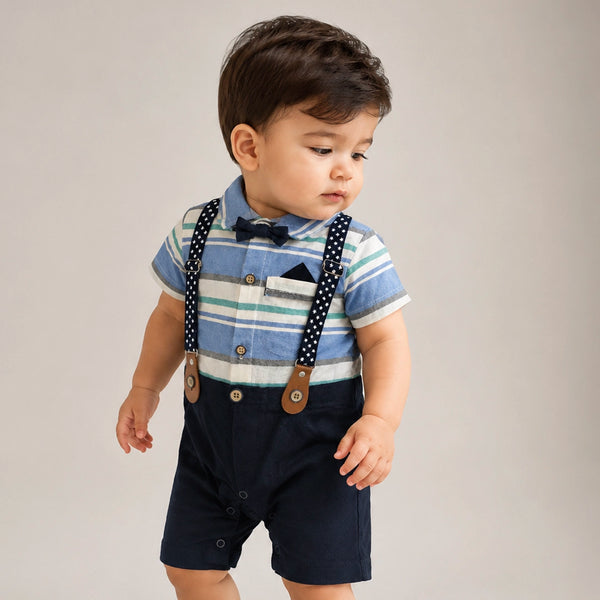 Child wearing a striped shirt, navy shorts, and suspenders on a plain background