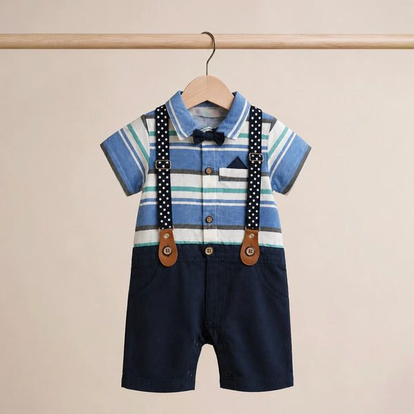 Children's outfit with striped shirt, navy shorts, and suspenders on a beige background