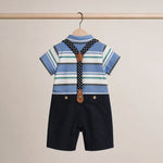 Children's outfit with striped shirt, suspenders, and black shorts on a beige background