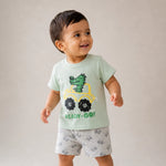 Child wearing a light green t-shirt with a dinosaur graphic and 'READY-Go!' text, standing against a plain background.