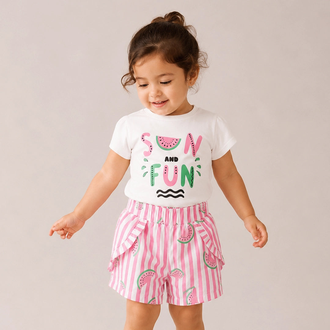 Child wearing a white t-shirt with watermelon design and pink striped shorts on a plain background