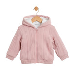 Pink baby jacket with a hood on a wooden hanger against a white background