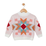 Children's sweater with geometric pattern on a wooden hanger against a white background