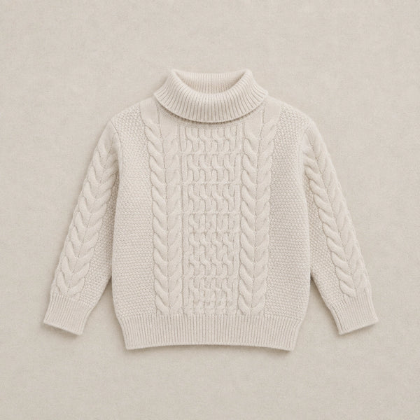 Beige cable knit sweater on a wooden hanger against a white background