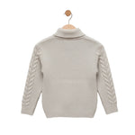 Beige knitted sweater with braided sleeves on a wooden hanger against a light gray background