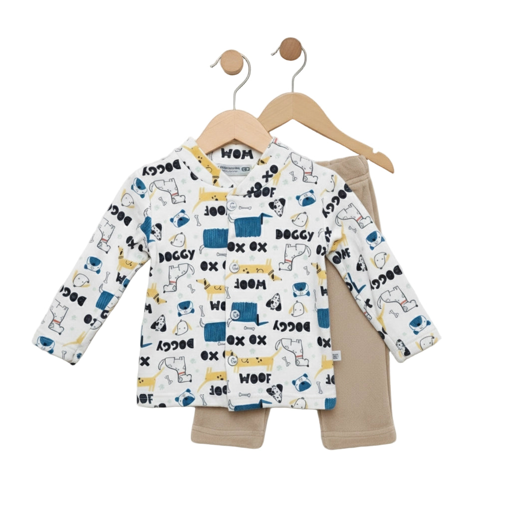Children's outfit with patterned long-sleeve shirt and beige pants on hangers against a white background