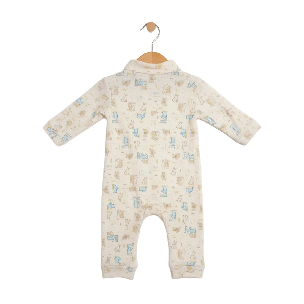 Baby onesie with animal pattern on a hanger against a white background