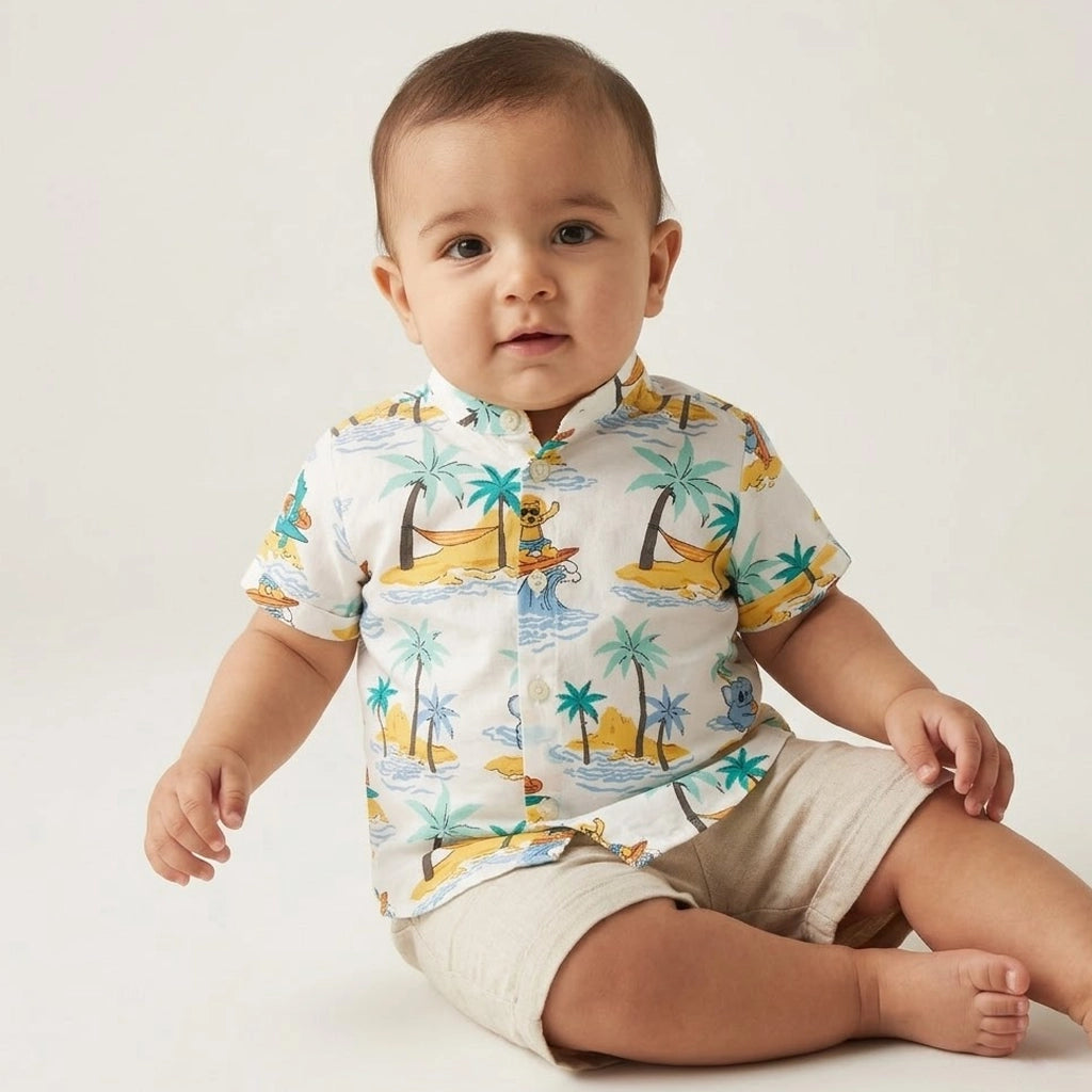 Child wearing a colorful shirt with beach-themed design on a gray background