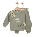 Children's green outfit with tiger design and 'wild at heart' text on a white background