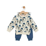Children's sweater with bear pattern and blue pants on a hanger against a white background