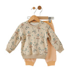 Children's outfit with patterned top and plain pants on a hanger against a white background