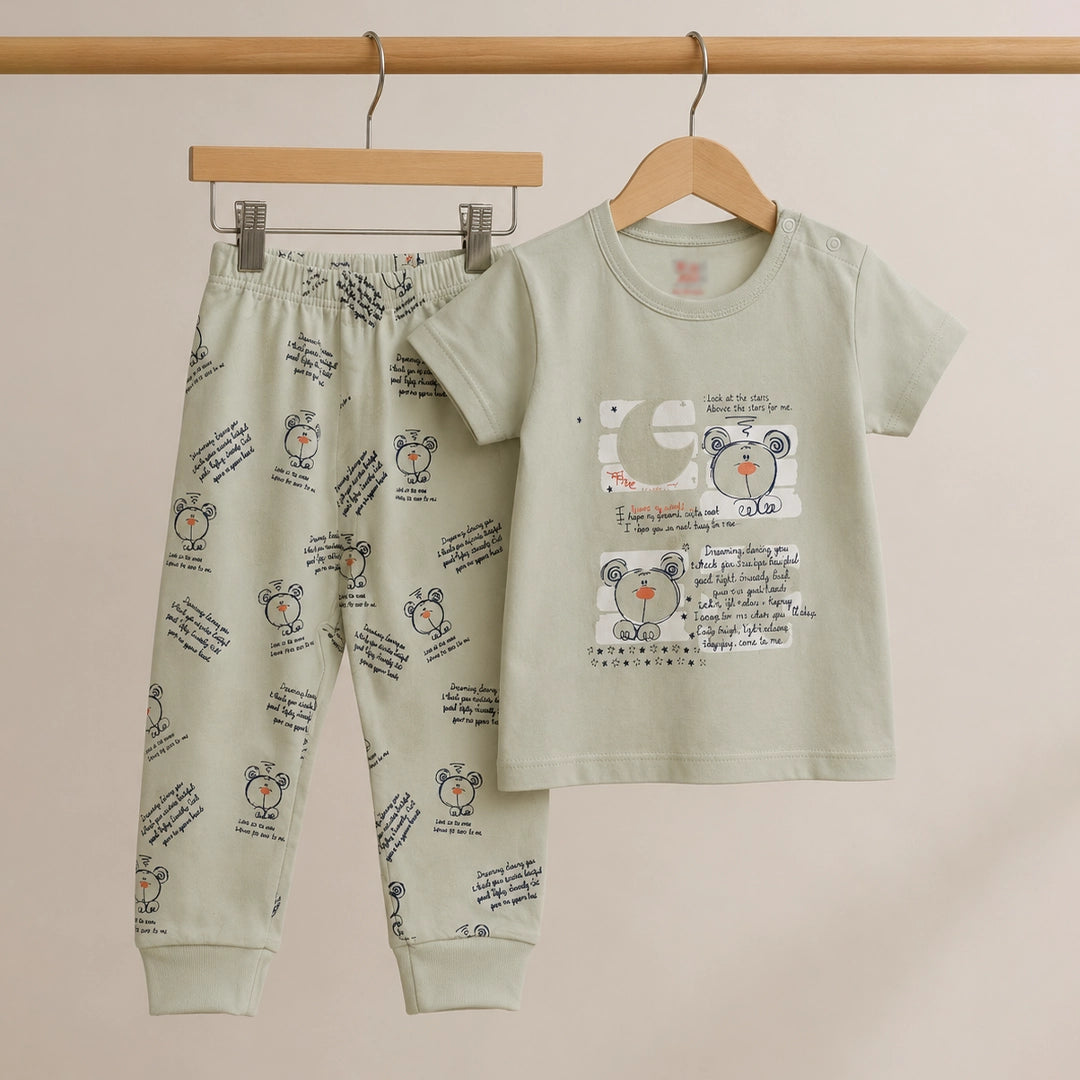 Children's pajama set with teddy bear design on a beige background
