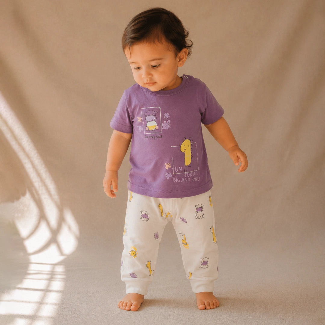 Child wearing a purple shirt and white pants with yellow patterns on a beige background