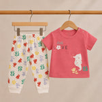 Children's pink shirt with 'Little Love' and seahorse design, paired with colorful floral pants on a beige background.