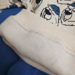 Close-up of a fabric with cartoon characters and blue accents