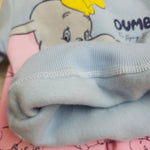 Close-up of a cartoon character on a piece of fabric with visible stitching.