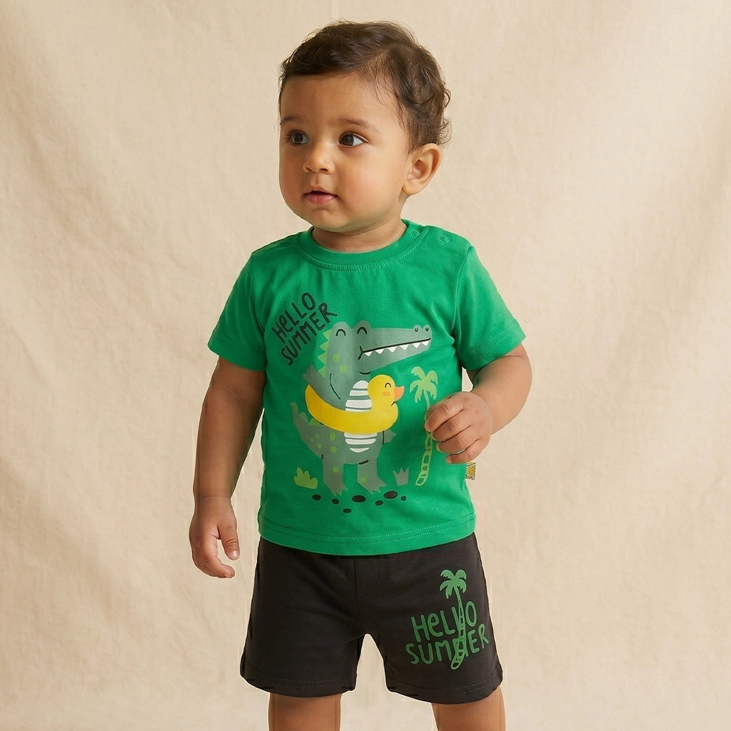 Child wearing a green t-shirt with a dinosaur graphic and black shorts on a beige background