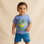Child wearing a blue t-shirt with a dinosaur graphic and 'Hello Summer' text on a beige background