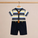 Children's outfit with striped shirt, suspenders, and shorts on a beige background