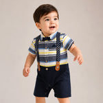Child wearing a striped shirt, suspenders, and shorts on a plain background