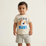 Child wearing a 'Little Dude' t-shirt with a graphic design on a plain background