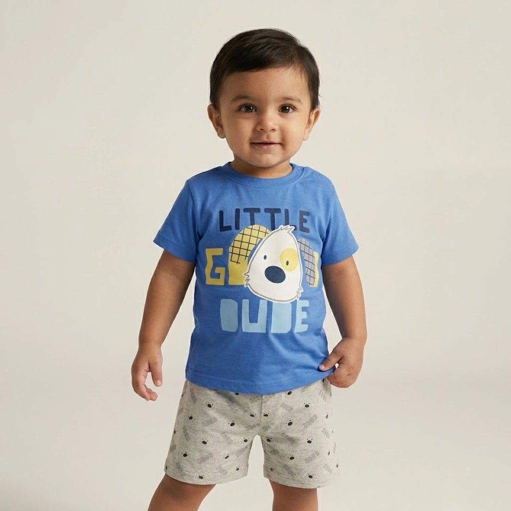 Child wearing a blue t-shirt with a graphic and text, standing against a plain background