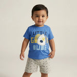 Child wearing a blue t-shirt with a graphic and text, standing against a plain background