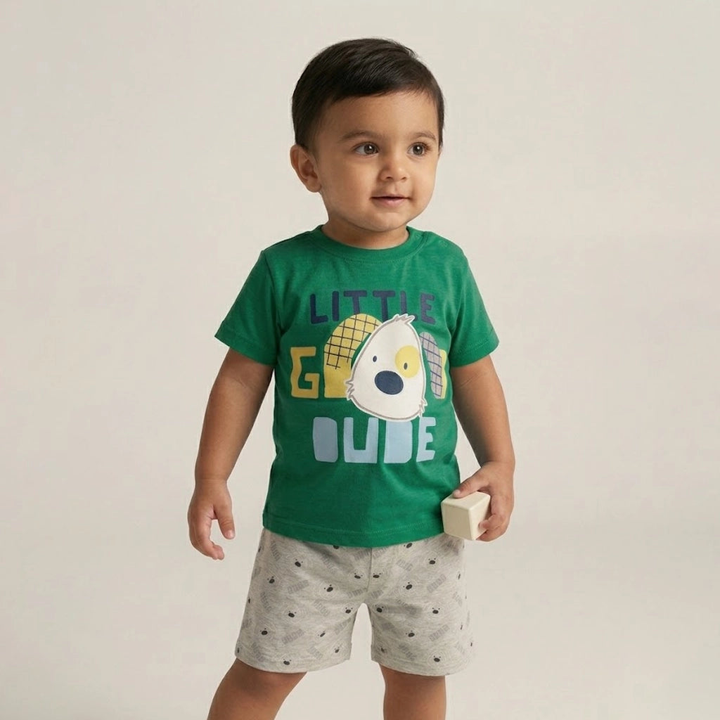 Child wearing a green t-shirt with a graphic design and text, standing against a plain background
